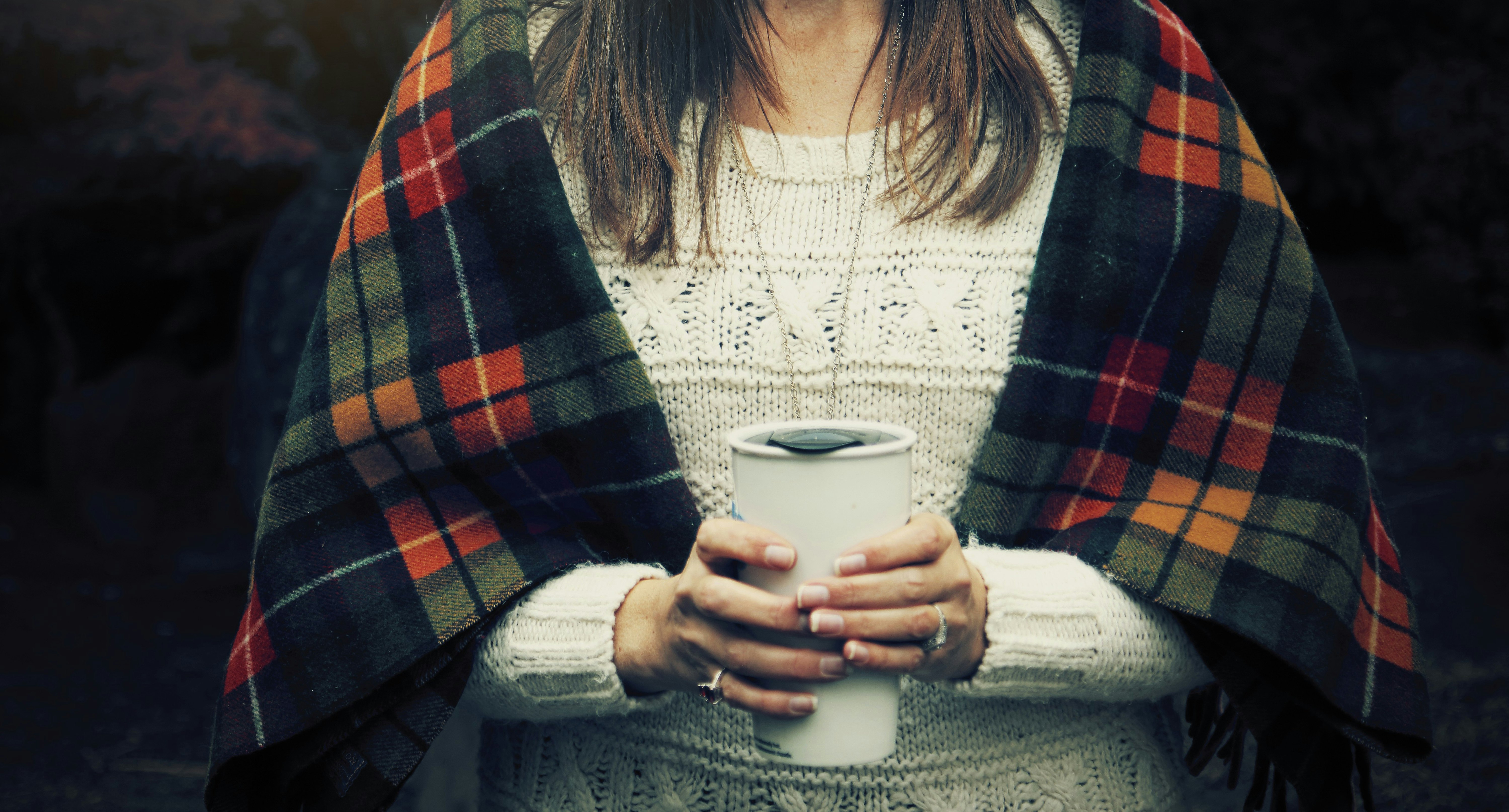 woman holding white cup